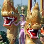Two Thai woman perform next to naka statues during parade kick off of the Songkran festival in Bangkok. Thailand's famed Songkran water festival, which commemorates the kingdom's traditional lunar new year, usually falls in April.