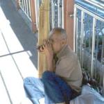 A street musician plays the unique looking bamboo kaen.